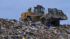 Bagr třídící hromady odpadu